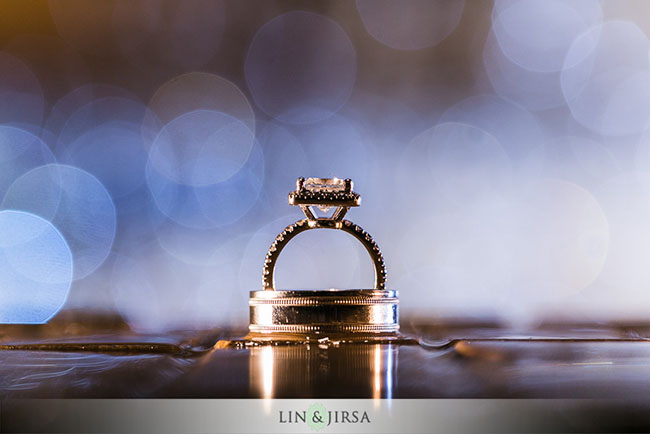 01-fairmont-newport-beach-wedding-photographer by Lin and Jirsa Bride's diamond engagement ring standing upright on groom's wedding band using putty technique