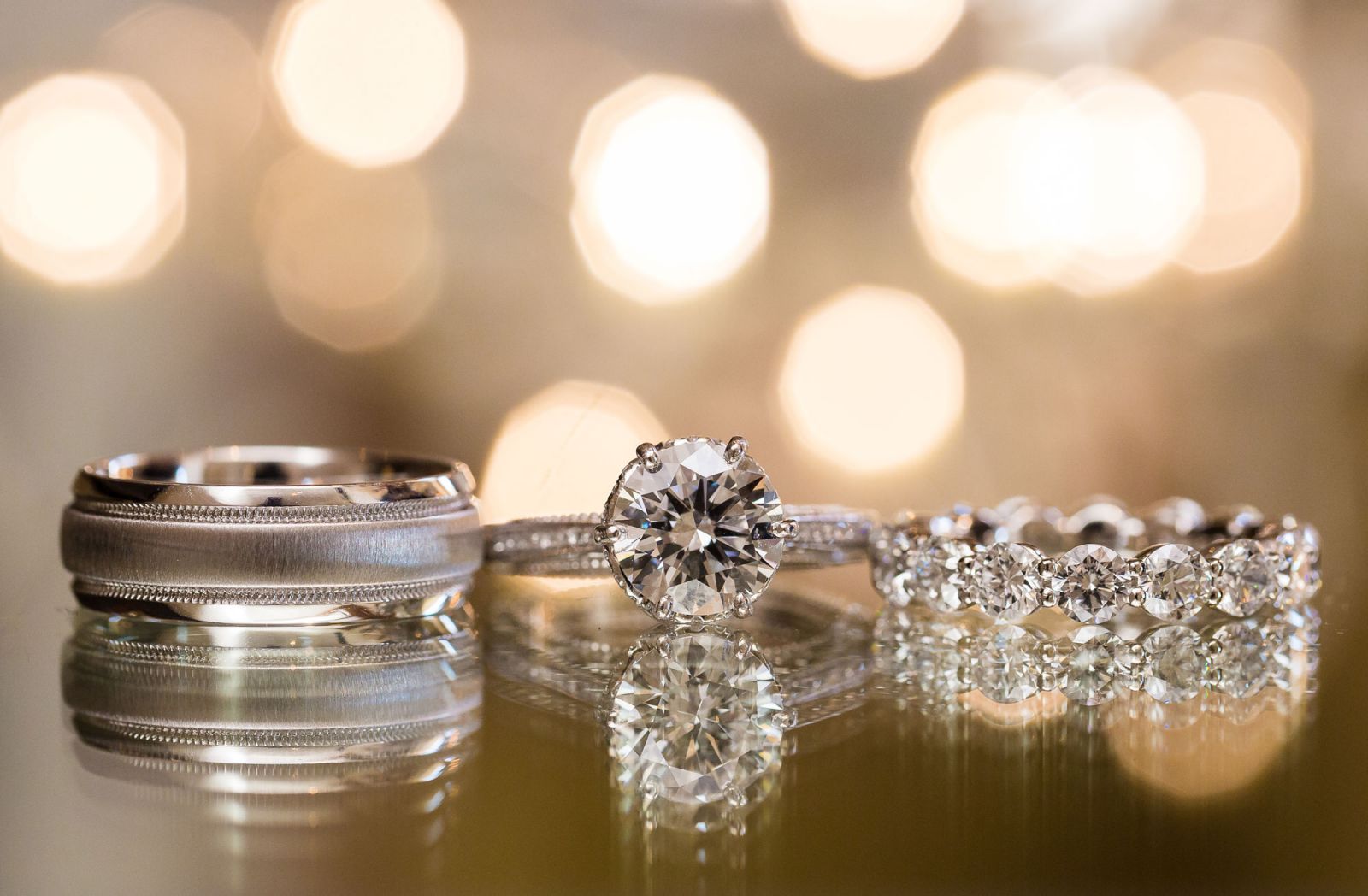 Wedding rings with colorful LED string light bokeh creating dreamy background