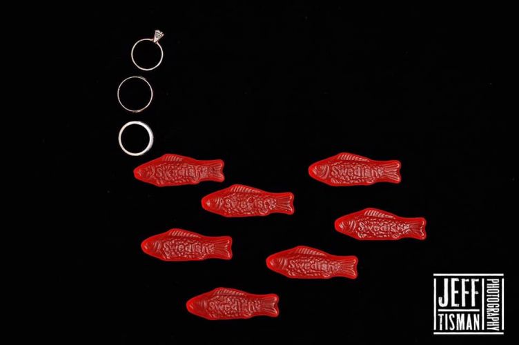 Wedding rings arranged with Swedish Fish candy creating playful bubble effect composition