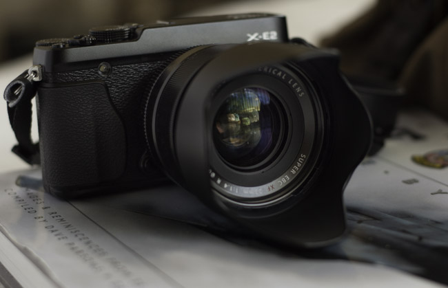 Fuji XF 35mm lens demonstrating how light transmission through multiple glass elements differs from the theoretical f-ratio due to absorption and reflection losses