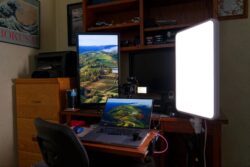 Photography workspace with camera, laptop, and lighting for professional shoots.