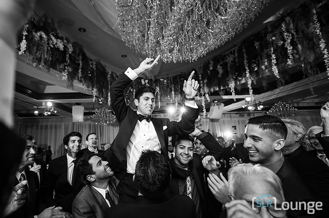 Wedding reception photograph showing how continuous autofocus is used to nail focus in poor light and close quarters at fast apertures